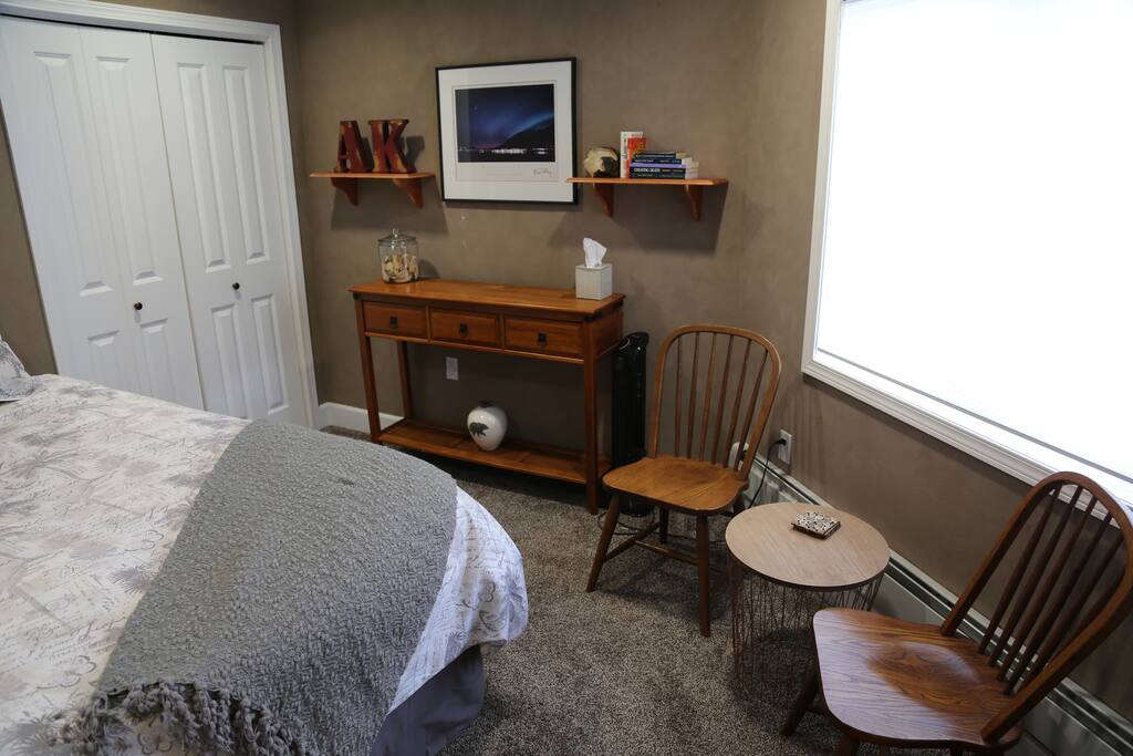 Bedroom #1 with a view of Mt. Juneau and the Gastineau Channel and attached bathroom with shower
