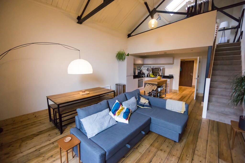 Open plan living area with mezzanine bedroom above