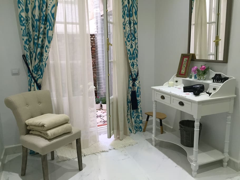 Main bedroom with double doors leading to internal patio, scented plants ,hairdryer, lots of mirrors .