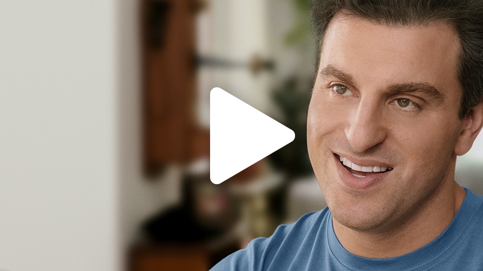 A thumbnail of Airbnb CEO Brian Chesky in mid conversation. A play icon is overlaid on the image.