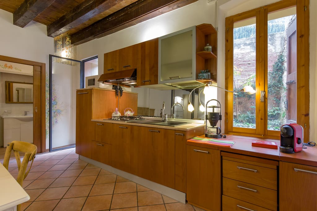 Kitchen with stove, microwave oven, dishwasher, coffee machine
