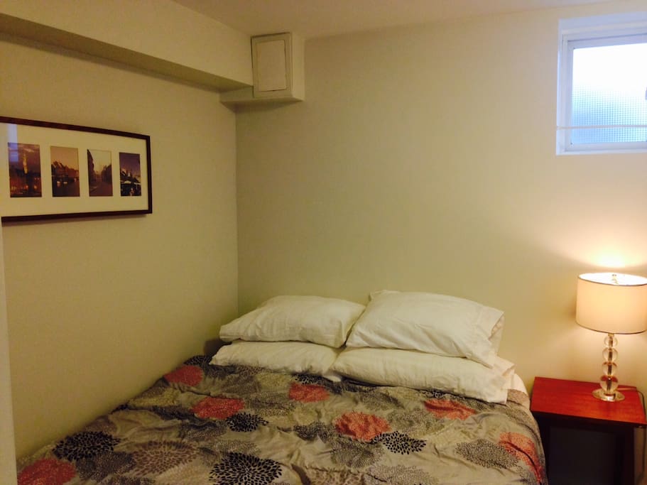 A queen size bed, with storage space underneath.