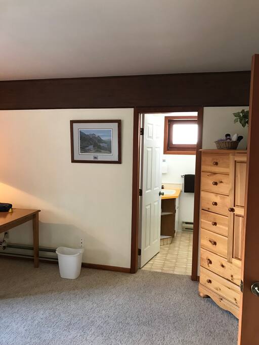 Armoire, entrance to bathroom, and edge of big table
