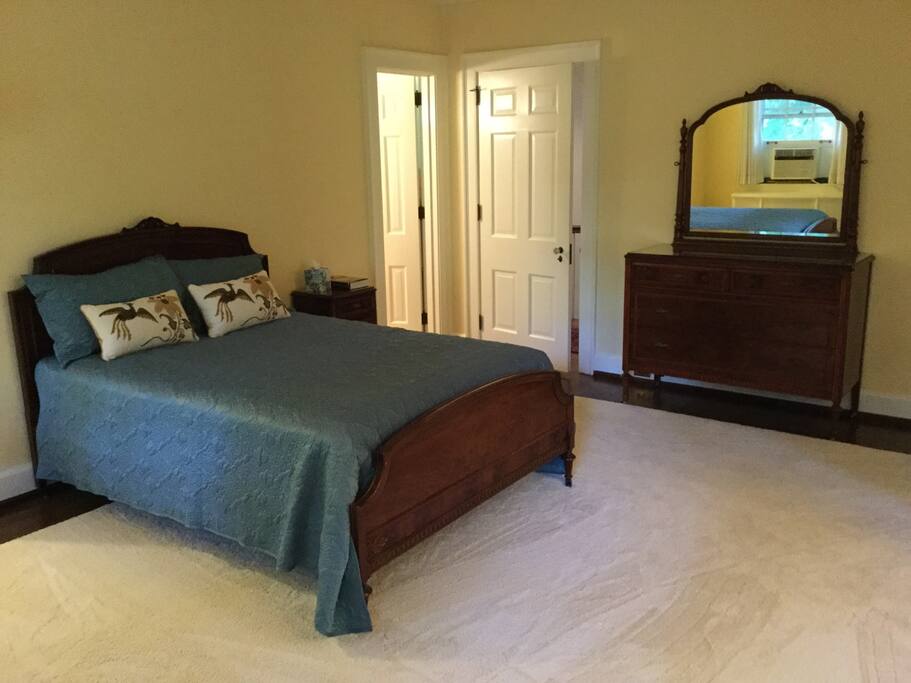 First bedroom is large and bright with hardwood floors and area carpet.