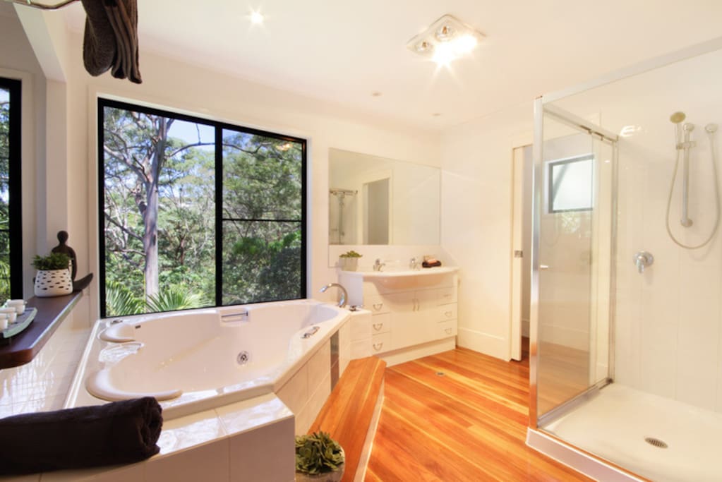 spa bath with forest and sea view