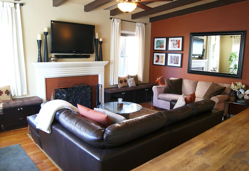 Living room with beamed ceiling, fireplace and TV
