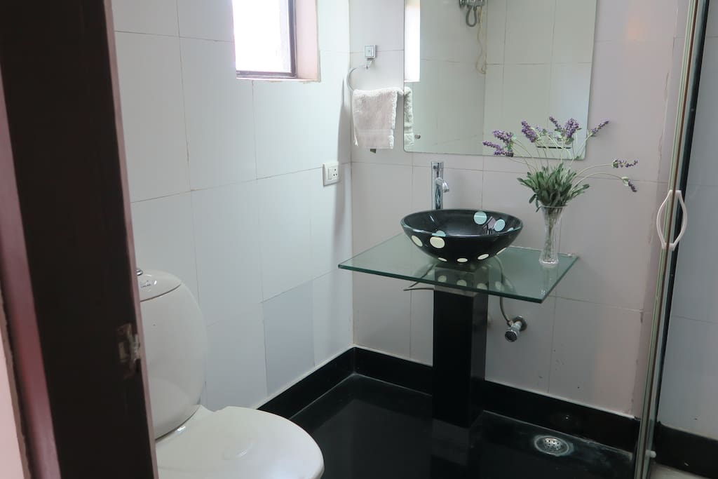 Attached bathroom with shower cubicle