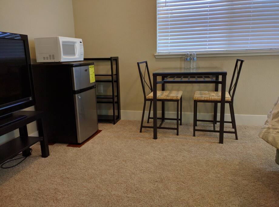 Mini-fridge, Microwave, Dining Table, and Small Shelf Provided