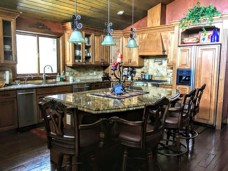 full service Chef's Kitchen with gas stove, trash compactor, granite countertops, open floor plan to dining room and great room and more
