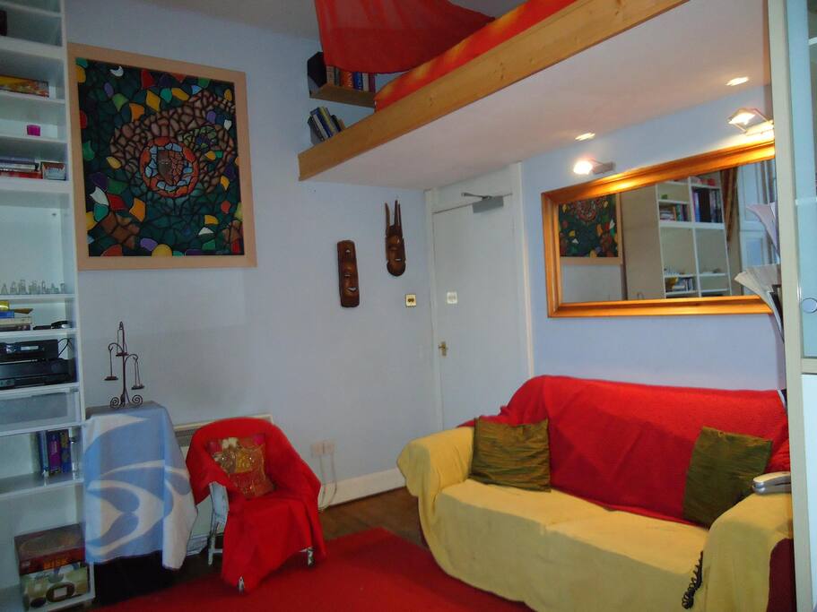 Living area with sofa, table/chairs for eating and good sound system which you are welcome to use (mindfully) or plug your phone into for good speaker sound.
