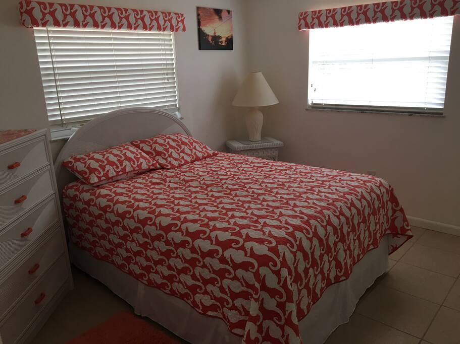 Queen bedroom with dresser, closet and TV