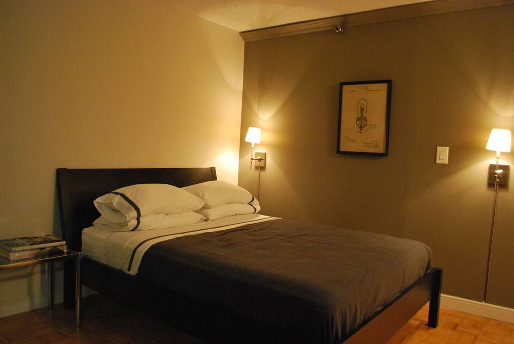 Bedroom area with Queen pillow-top comfort mattress, with extra pillows, and freshly laundered hotel linens.