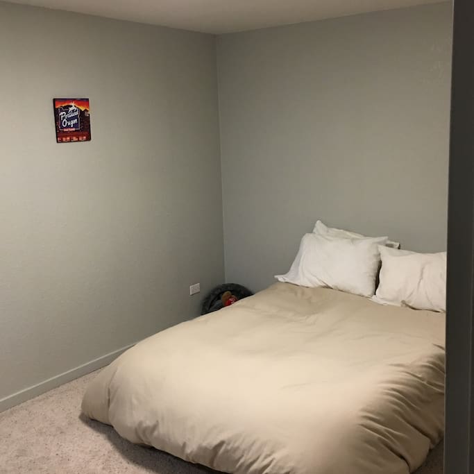 Bedroom. A futon, a closet, and a picture of my home town.