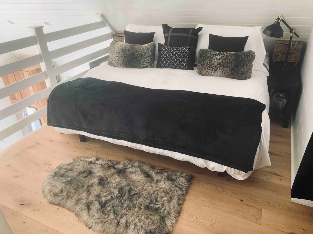 พื้นที่ด้านหน้าของห้องใต้หลังคา: เตียงคิงไซส์พร้อมเบาะรองนั่งและผ้ารองกันเปื้อน 