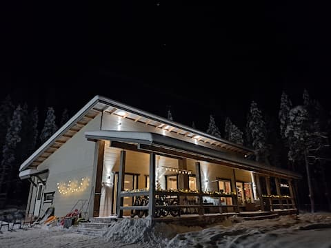 Modern log house at the lakeside with Aurora view