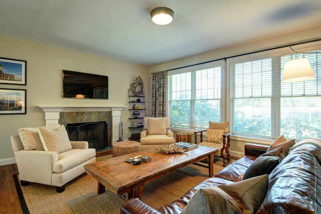 big comfortable sitting area with large smart tv and wood burning fireplace
