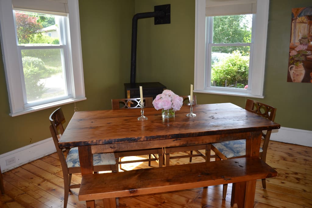 Light-filled dining room seats six at our farmhouse table (high chair available).