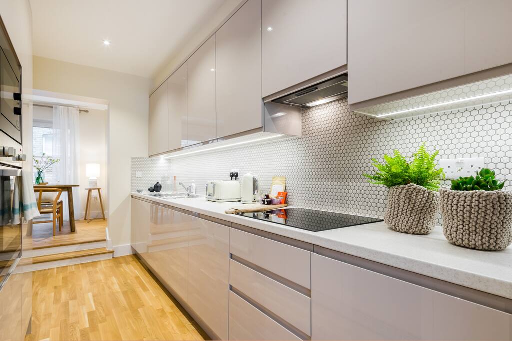 The sleek and modern kitchen is brand new.