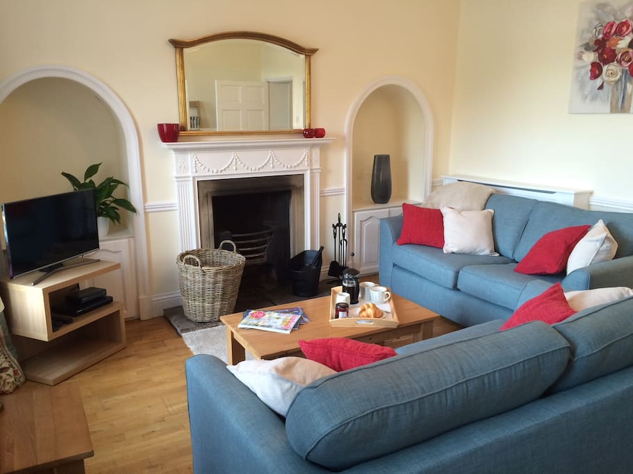Spacious sitting room overlooking The Green with log burner