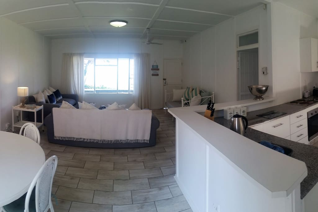 panoramic photo of lounge, dining room and kitchen