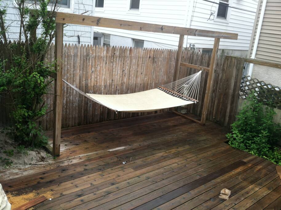 Private backyard with BBQ, dining and lounge areas.