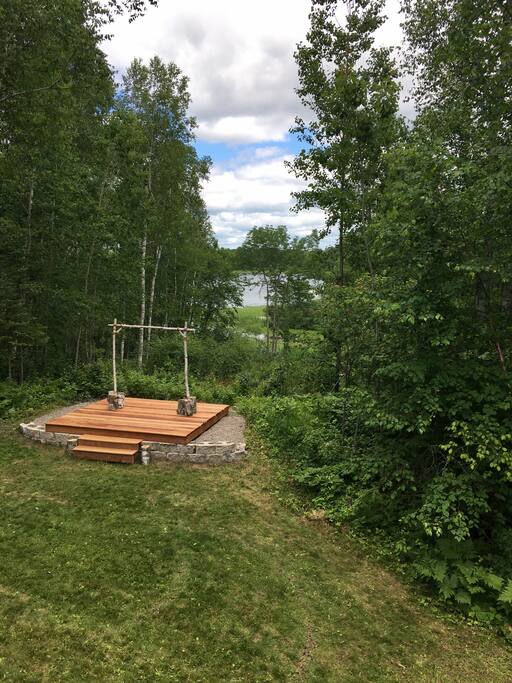 Back yard, there is a fire pit on the platform now