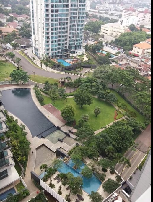 View from the roof of building with jogging path and swimming pool in this picture.