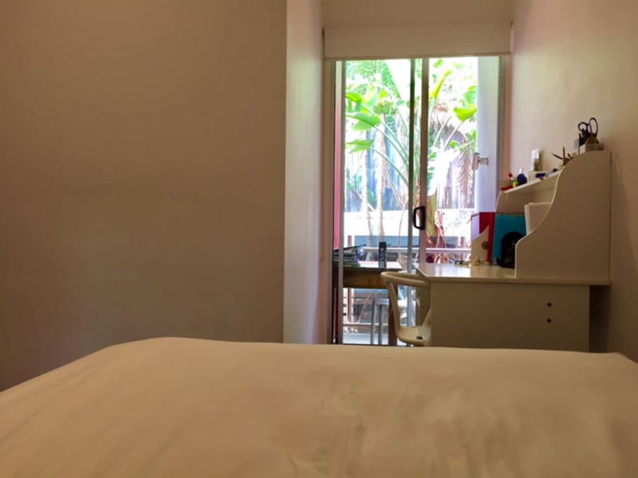 Room opens to small balcony overlooking rear courtyard