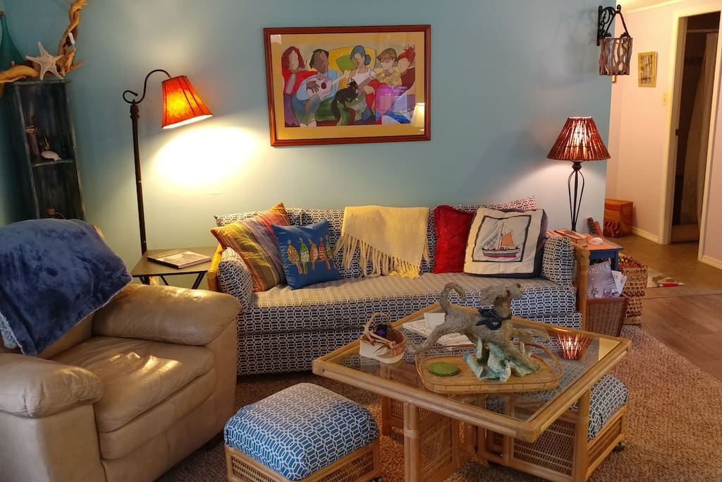 There is ample seating in the relaxed Beach Inspired living room It is the perfect place for playing one of the many provided games. doing a puzzle, streaming movies and favorite shows or reading a good book by the fireplace.