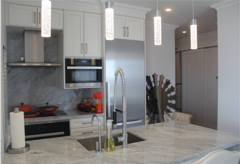 Kitchen: Instant Filtered Cold/Hot water, Breakfast Bar, Dishwasher, Induction Cooktop, Microwave, Oven, Bar Stool