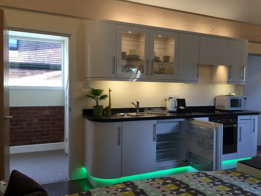 Plenty of china, cups and wine glasses in the cupboards and here is the fridge/freezer!