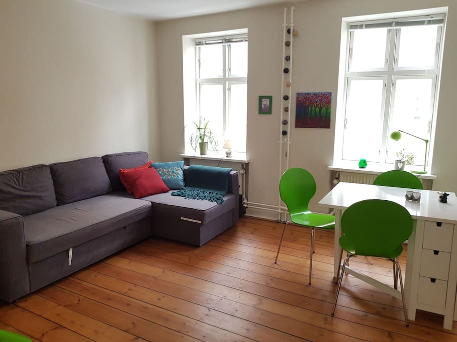 Living room with a pull out sofa you can sleep in. There are also 2 floor mattresses if needed and 4 chairs.