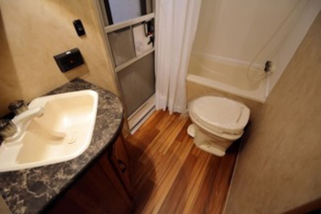 Bathroom complete with a shower and bath and convenient door to come in directly from outside
