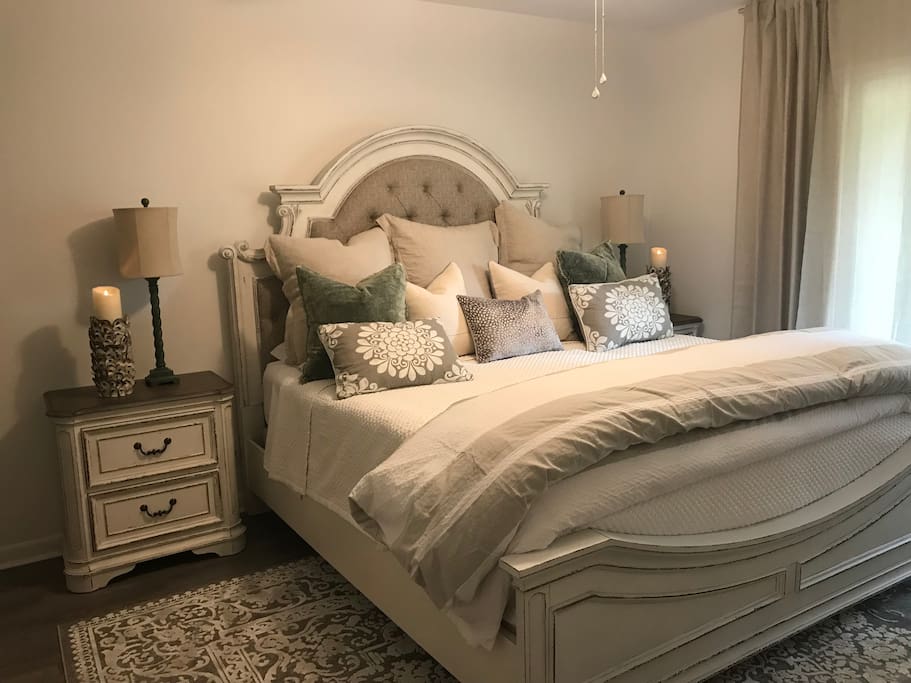 Master bedroom with king bed and sliding door that open to the front porch.