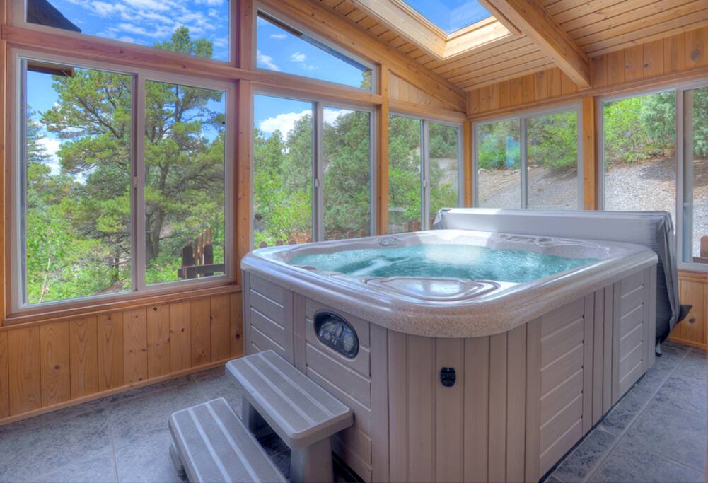 Hot tub sunroom in Hawks Nest vacation rental cabin in Durango Colorado
