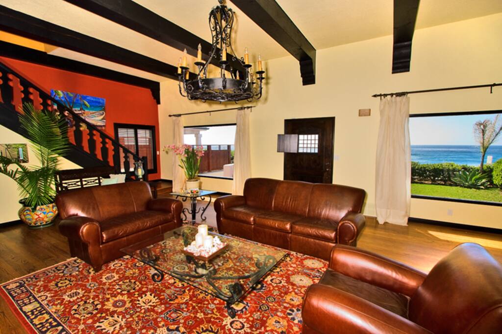 Comfortable living room has views and high beamed ceilings.