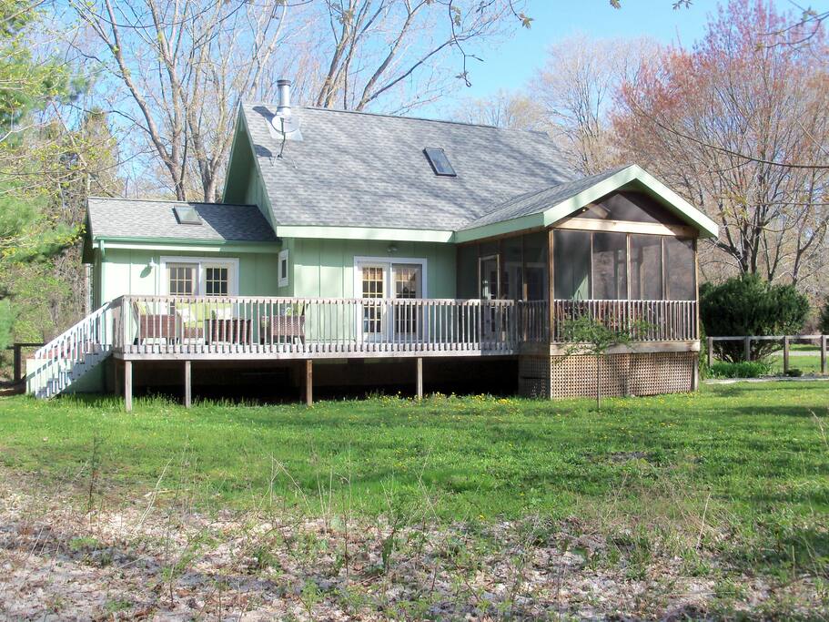 Deck on one side of house that faces woodlands