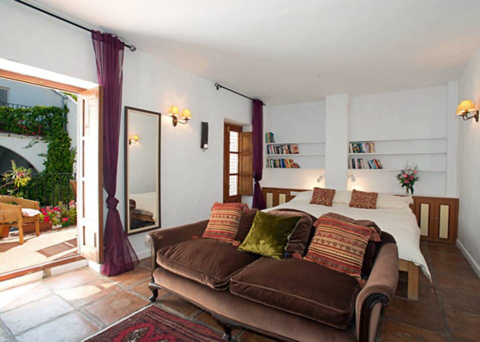 Emperor size Bed and terrace overlooking pool