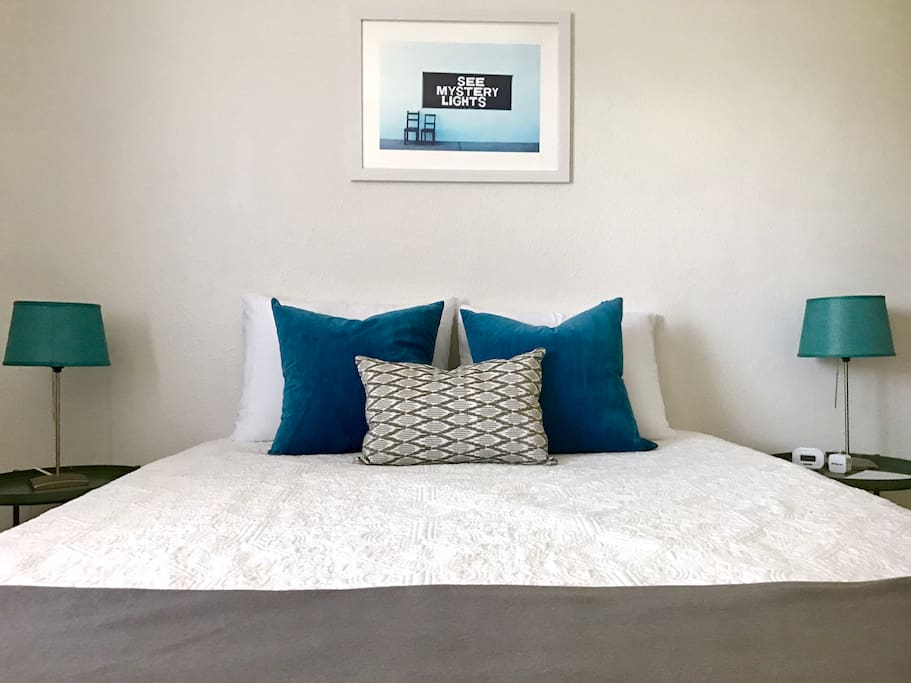 Blue Bedroom with queen size bed, dresser, full mirror, and walk in closet.
