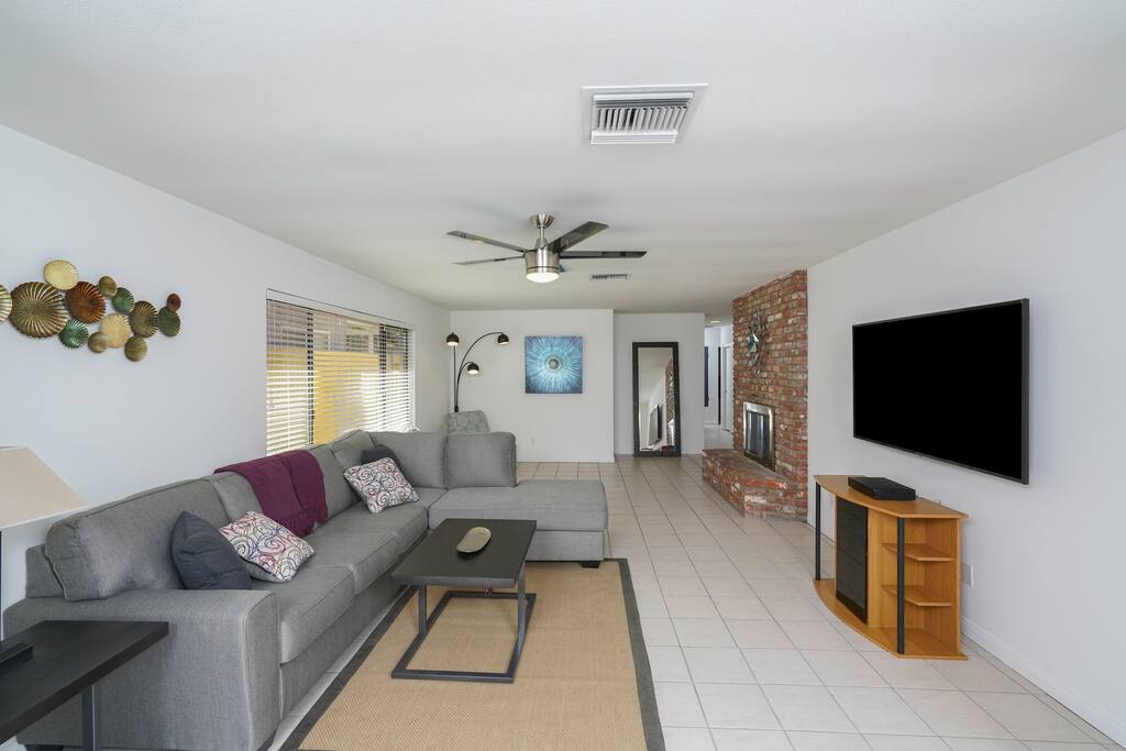 Living room sits 6 comfortably with a 70” smart TV; perfect for entertainment. Remote controlled fan/light. Two single seated lounging area in front of the fireplace with a clear view of the TV.