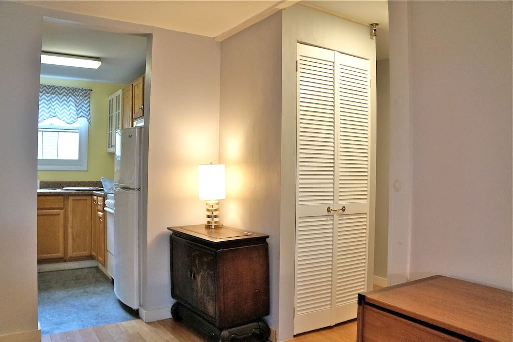 Kitchen, entrance hall with cabinet for washer/dryer.