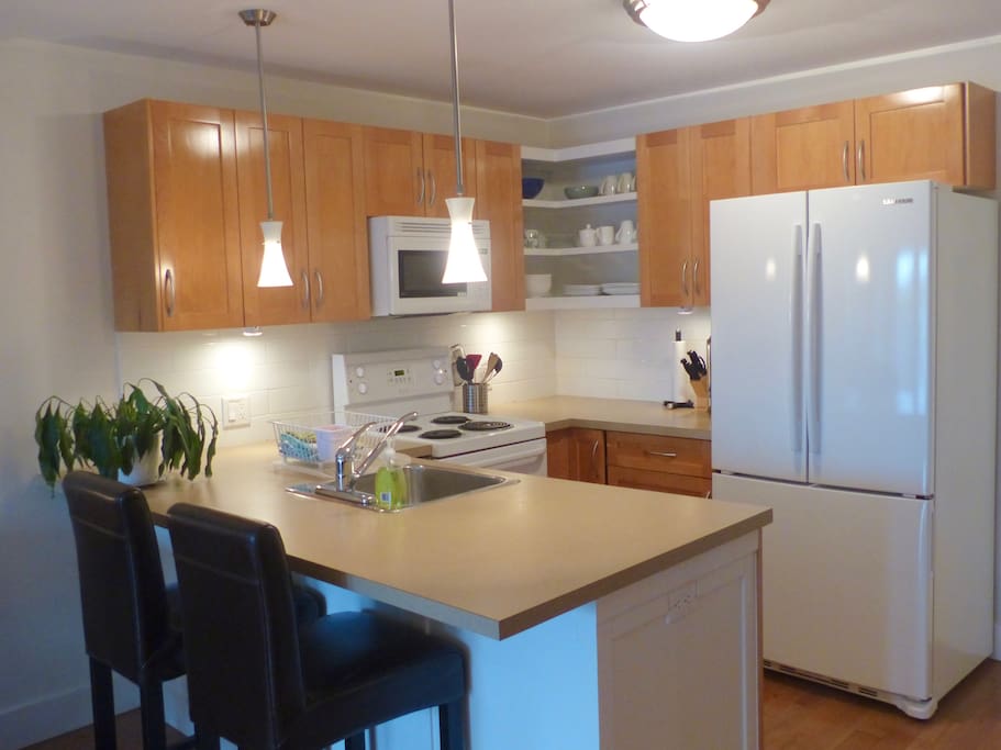 Kitchen is well stocked with microwave, stove, dishwasher French door fridge, toaster and kettle.
