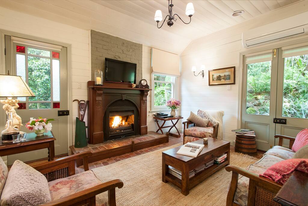 Cosy loungeroom with open fire in this historic cottage