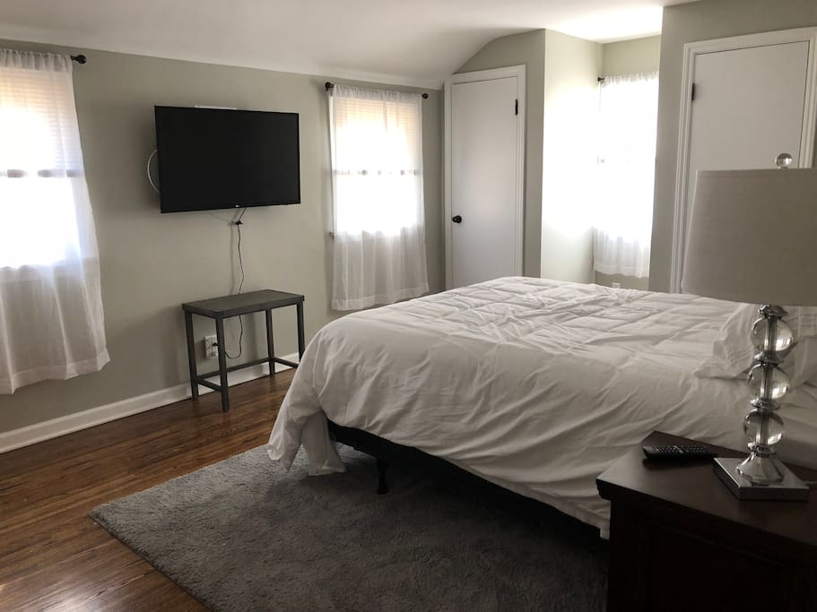 Master bedroom with TV, Apple TV, ironing board and iron