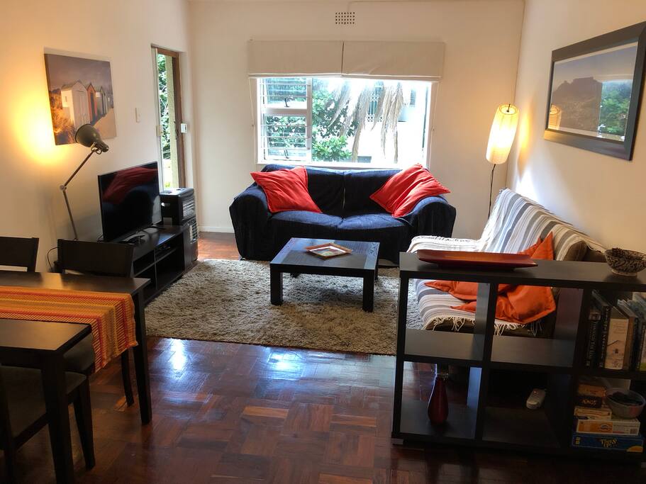 The large living room, with TV and access to the balcony