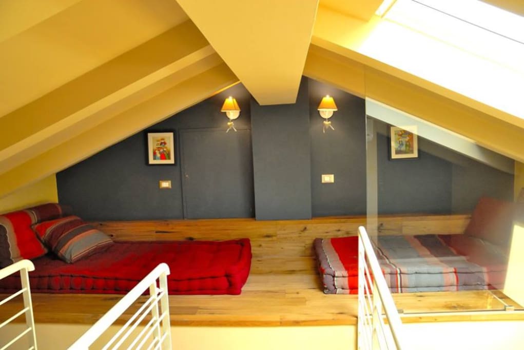 Single Mattress beds on the wooden floor of the attic space