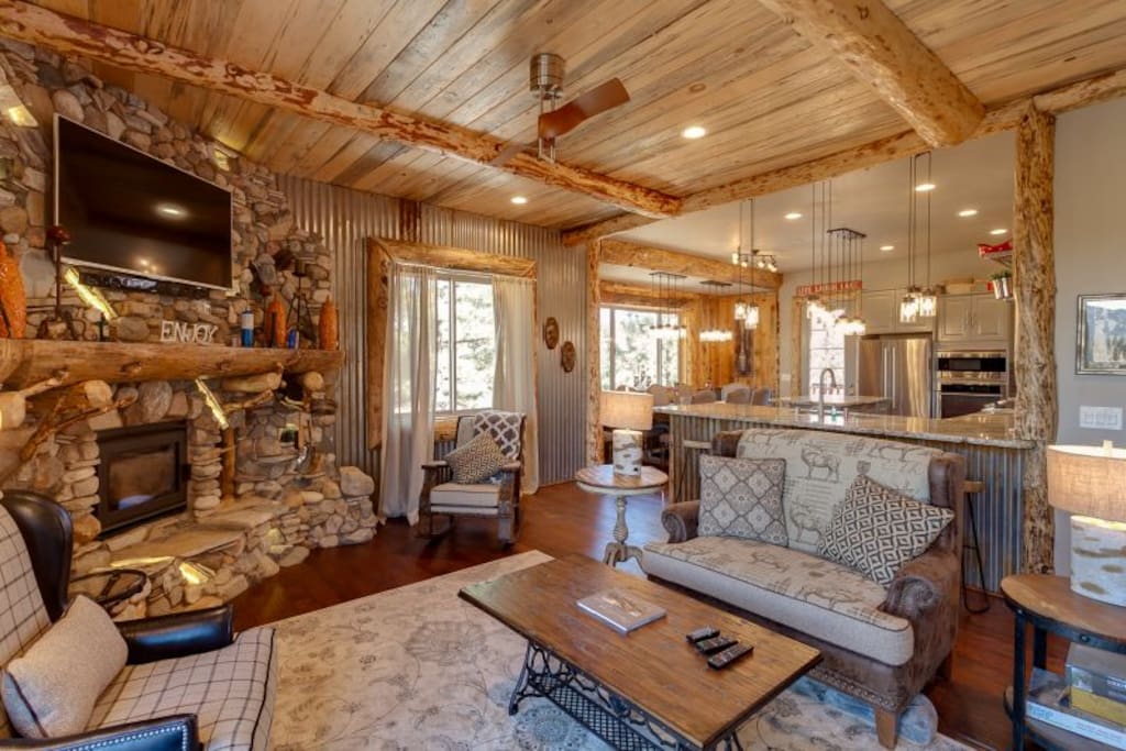 Designer open living area with Flatscreen and Romantic Fireplace.