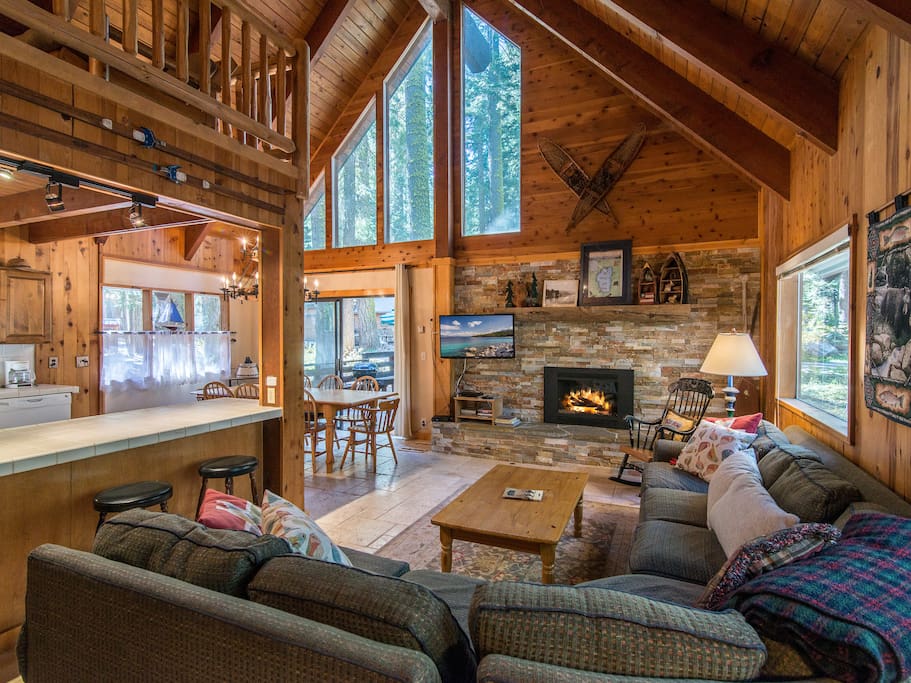 The main living area boasts high vaulted ceilings, charming knotty pine finishes, and a 42” flat screen TV.
