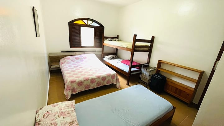 Chambre numéro 01, située au premier étage avec un lit double, un lit superposé et un lit simple 