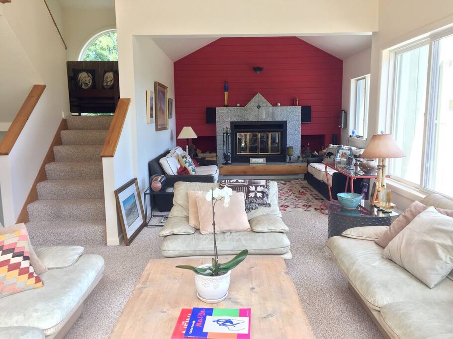 Main living room area with multiple couches, reading areas, and the cozy fireplace!